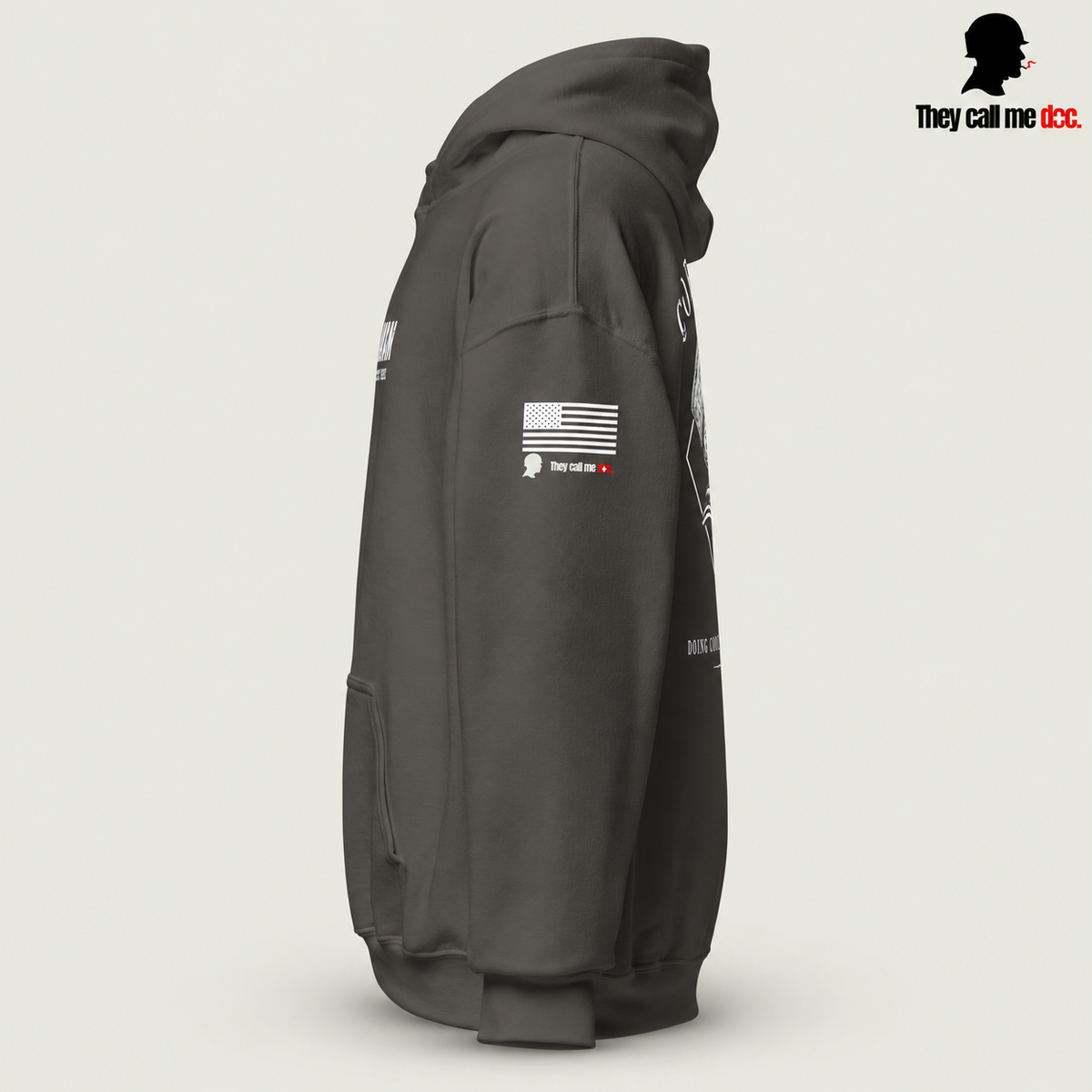 Corpsman 8404 Hoodie in charcoal — left sleeve view with American flag and They Call Me Doc logo